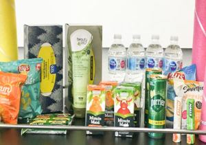 A selection of water bottles, juice, snacks and other foods